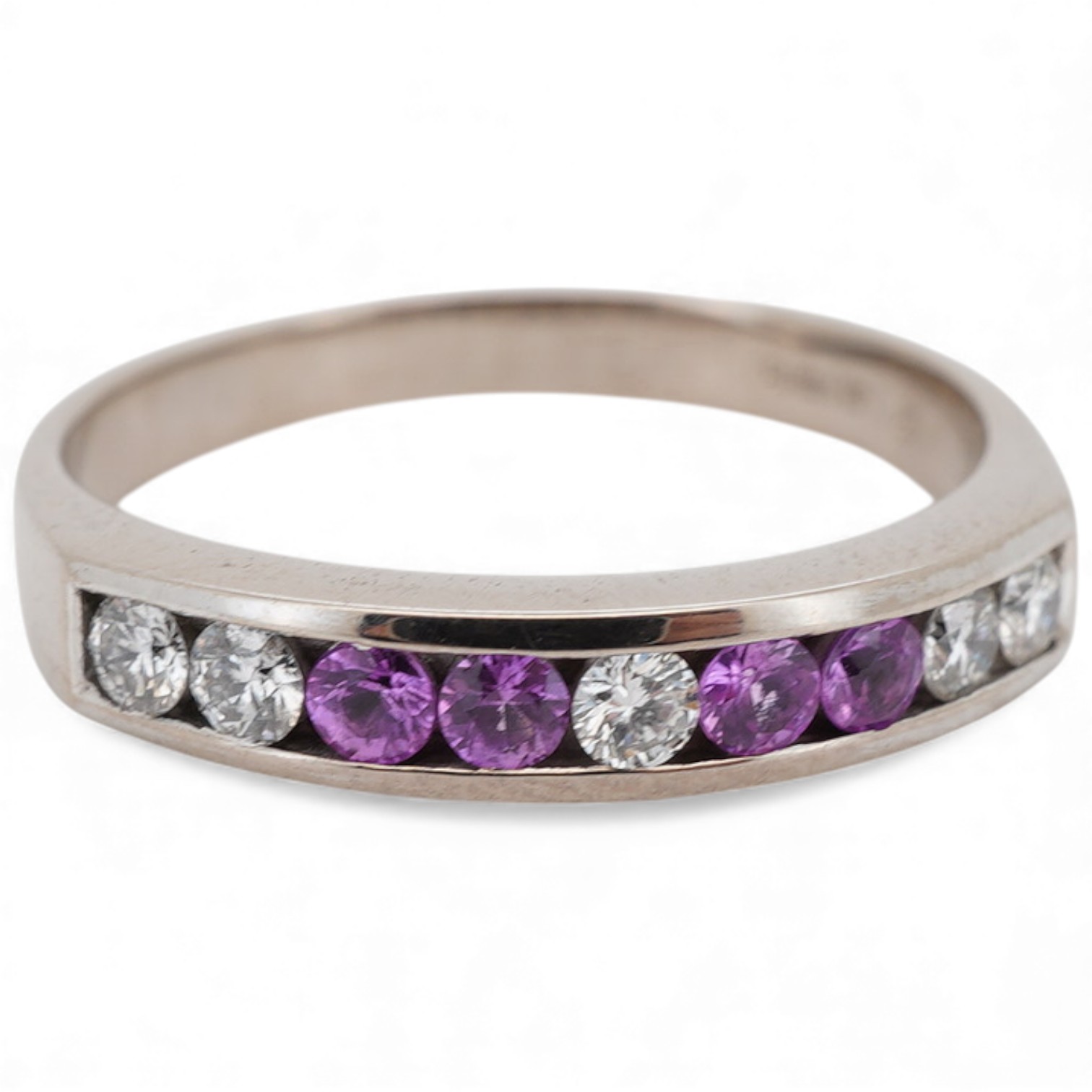 A recent 18ct white gold, four stone pink sapphire and five stone diamond set half hoop ring, size N, gross weight 3.6 grams.